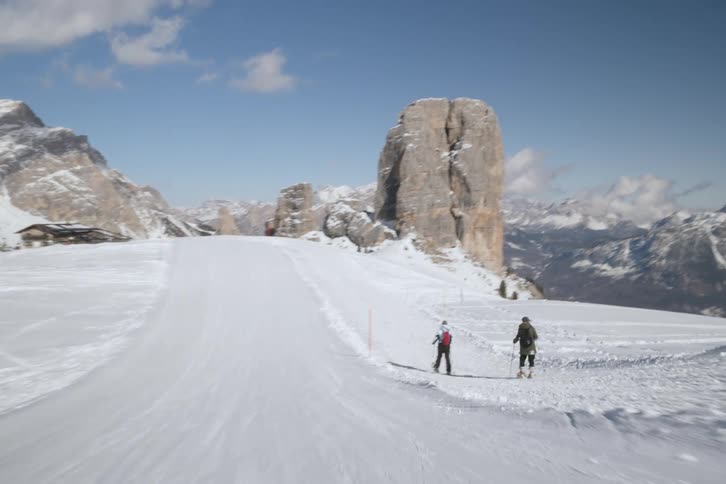 Two people skiing on a snowy mountain