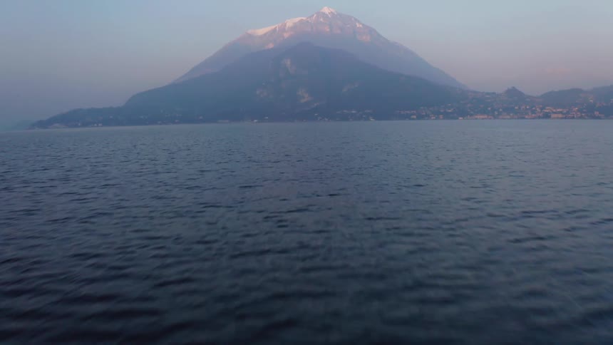 Aerial landscape of an ocean with mountains in the background