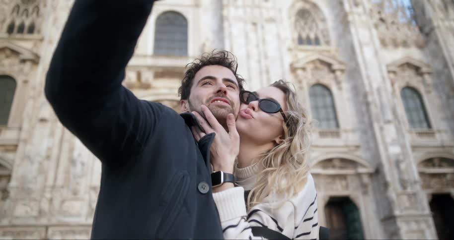 Couple taking a selfie next to a cathedral