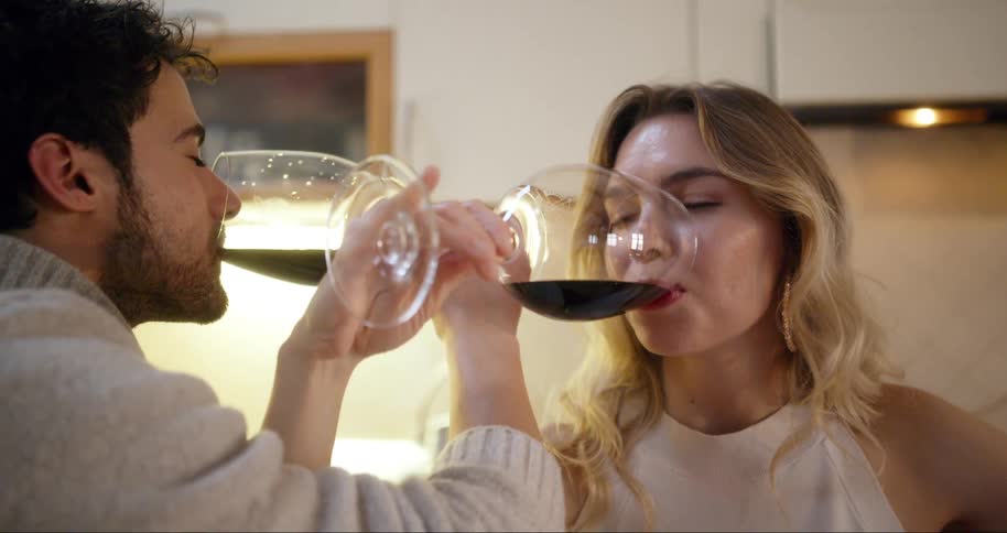 A footage of a man and a woman sharing a glass of wine