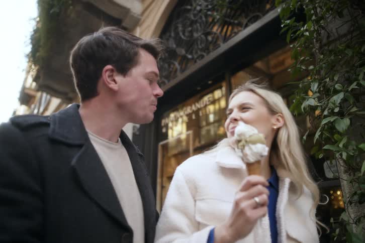 Couple have italian gelato together and kissing