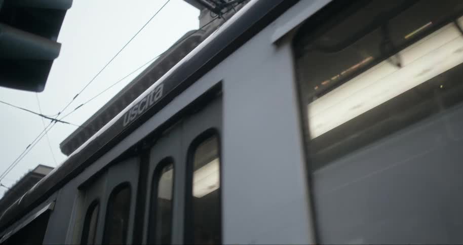 A trolley train rides down the city street