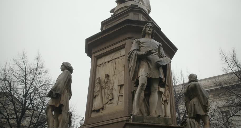 Monument with bronze statues outdoors on a cloudy day
