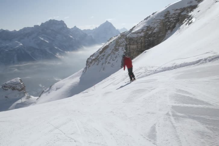 Person skiing down a snowy mountain