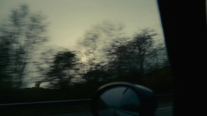A car driving through the countryside on a fall morning