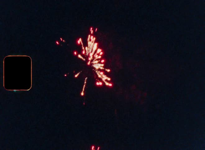 Several bright fireworks exploding in the night sky