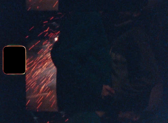 Couple standing near fireworks at night kiss each other
