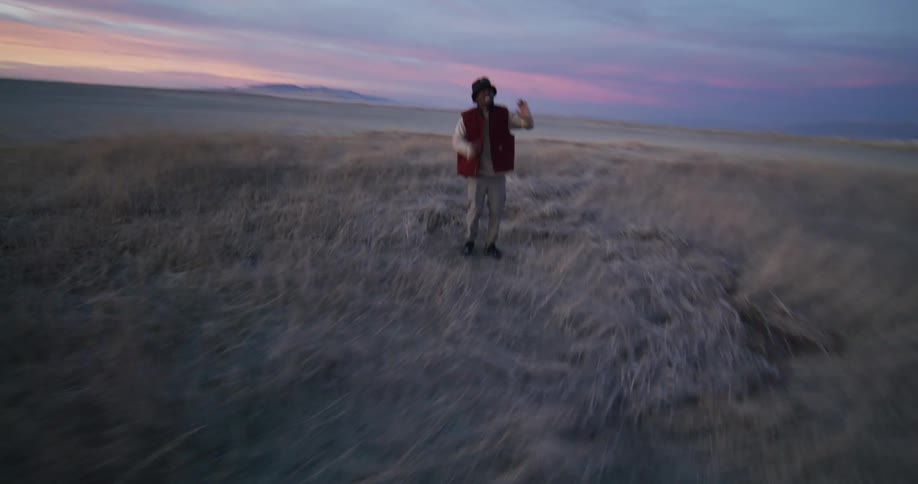 A man is break dancing at sunrise