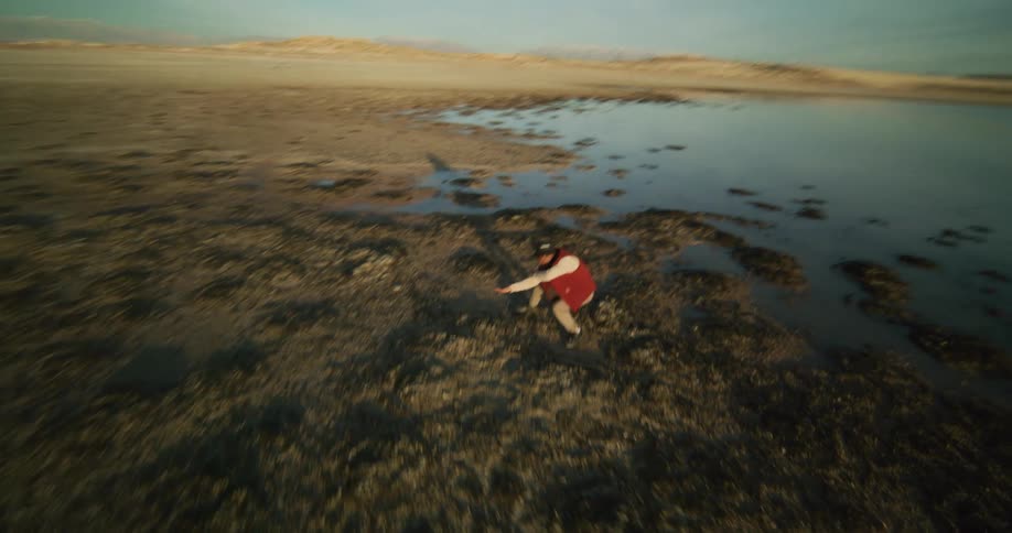 Man is dancing against the backdrop of an open outdoor landscape
