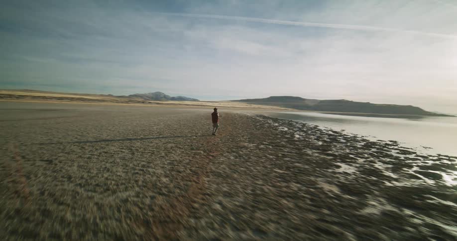 Man dances across a coastal landscape