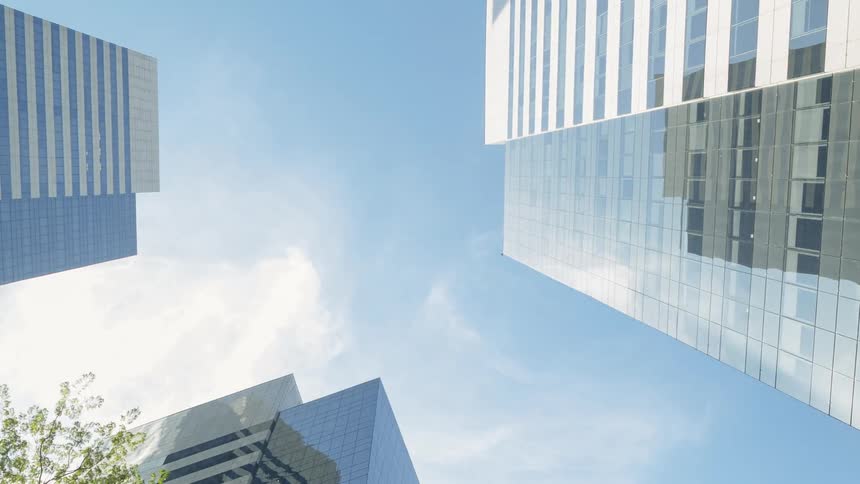 Clouds move in the sky over skyscrapers in a city