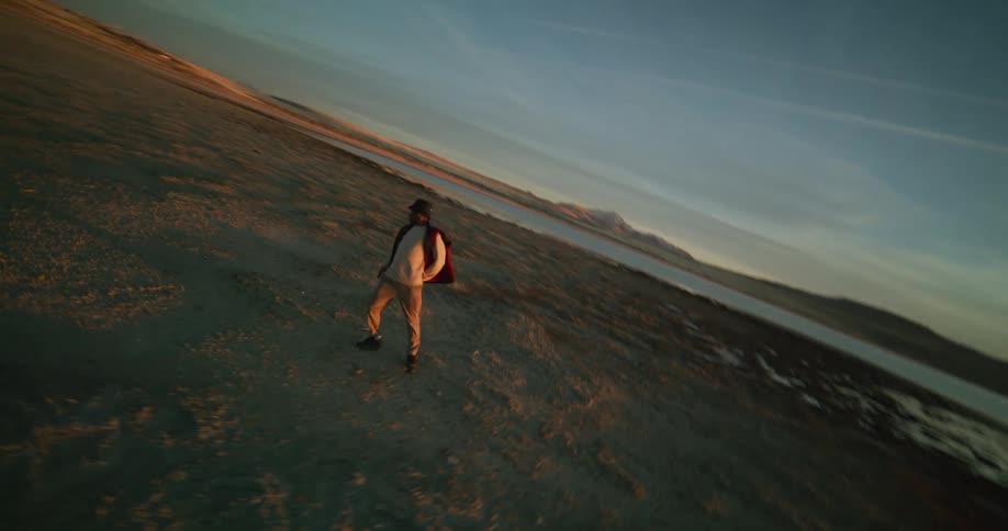 A man is break dancing by the lake