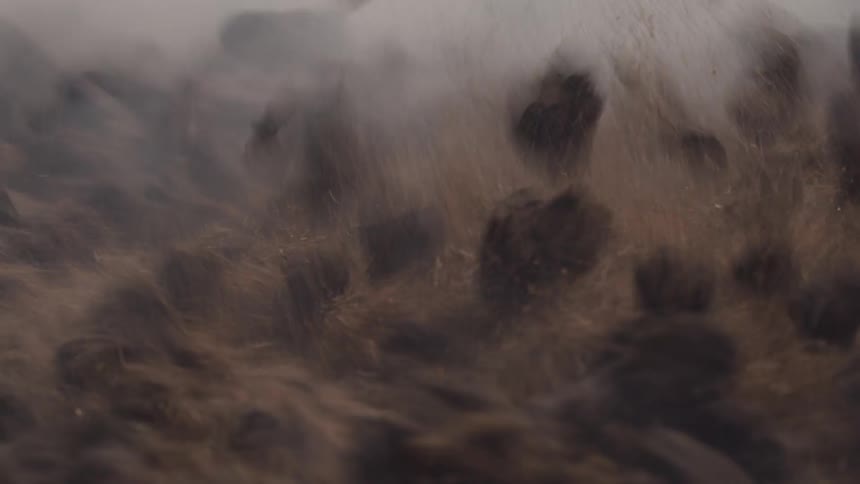 Close up of boulder with sand in abstract swirling motion
