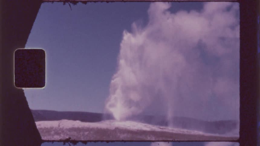 Geyser erupts releasing a column of steam and water into the air
