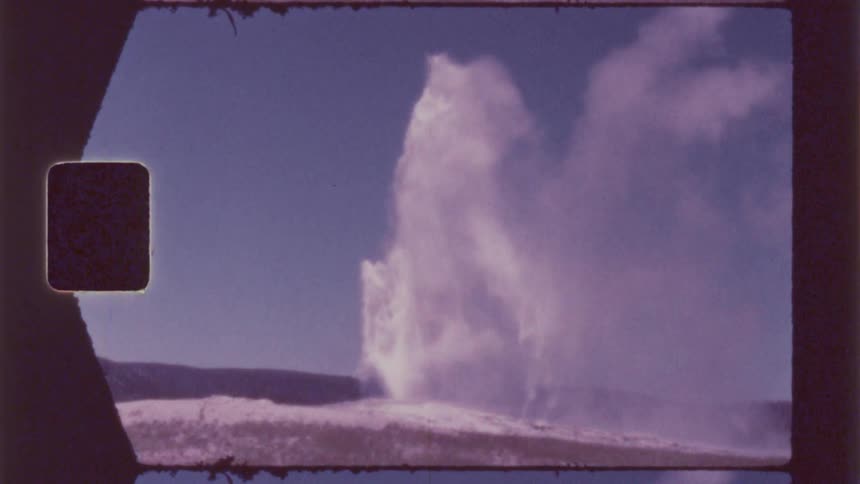 Geothermal eruption in a natural setting with steam and water being expelled into an openair environment