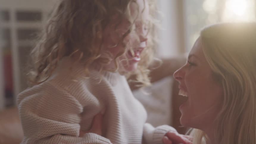 Woman and child are smiling and playing