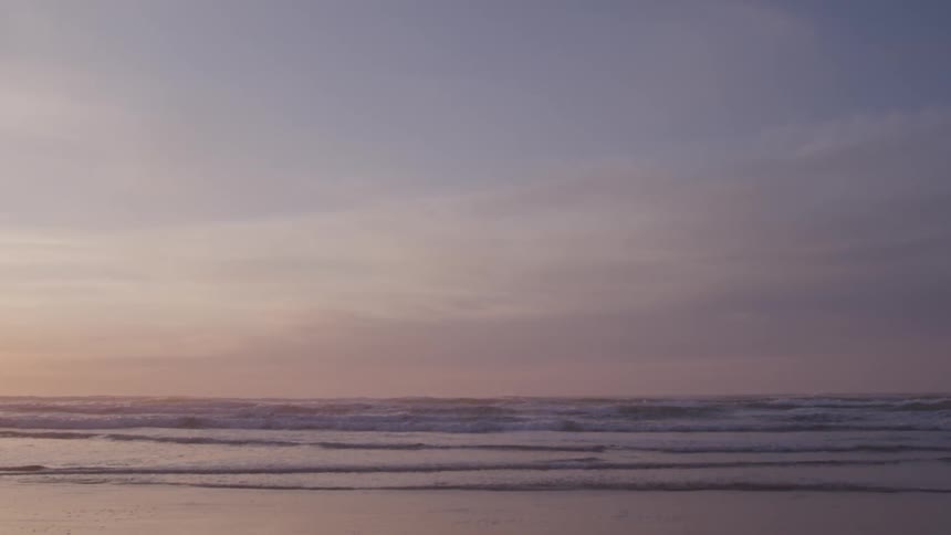Landscape of a calm beach and the sky in shades of purple