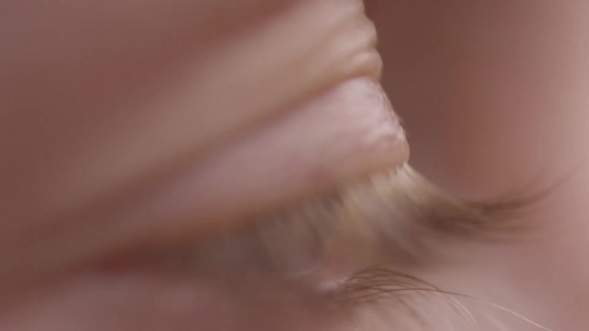 Extreme close up of a persons eye closing and opening