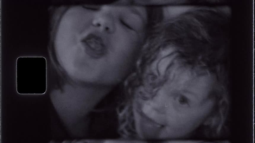 Portrait of two little girls sticking out their tongues making a face