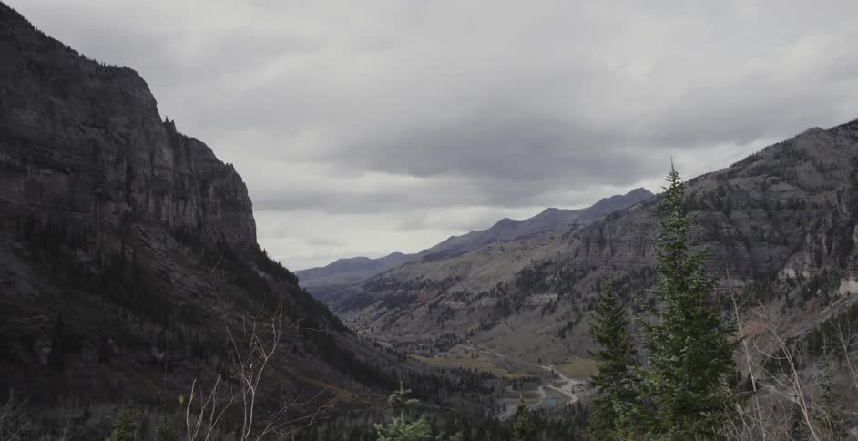 Clouds hovering above rock mountains