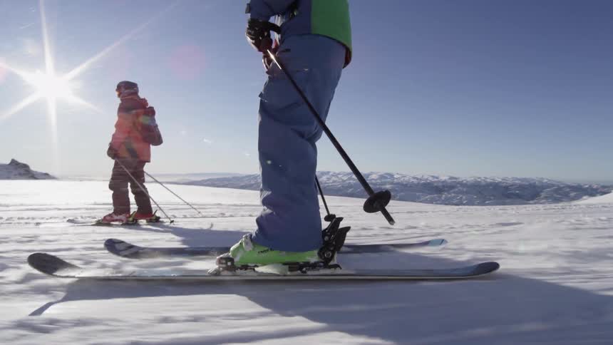A family skis down a mountain