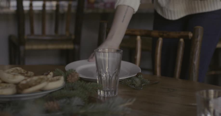 A woman sets the table