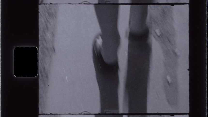 Closeup of the legs of a person wearing flipflops walking on the street