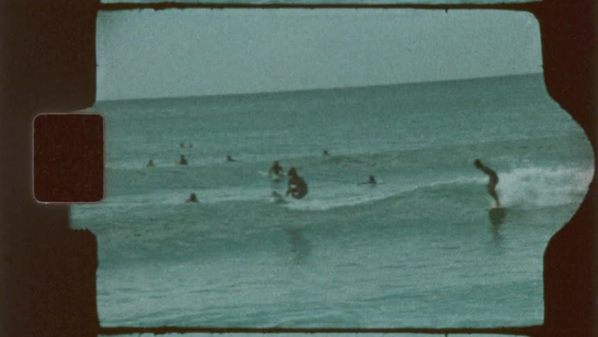 Surfers performing on waves at the beach