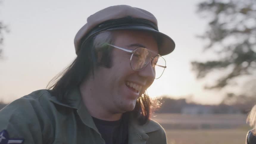 Portrait of a smiling man in a beret while standing in an outdoor setting