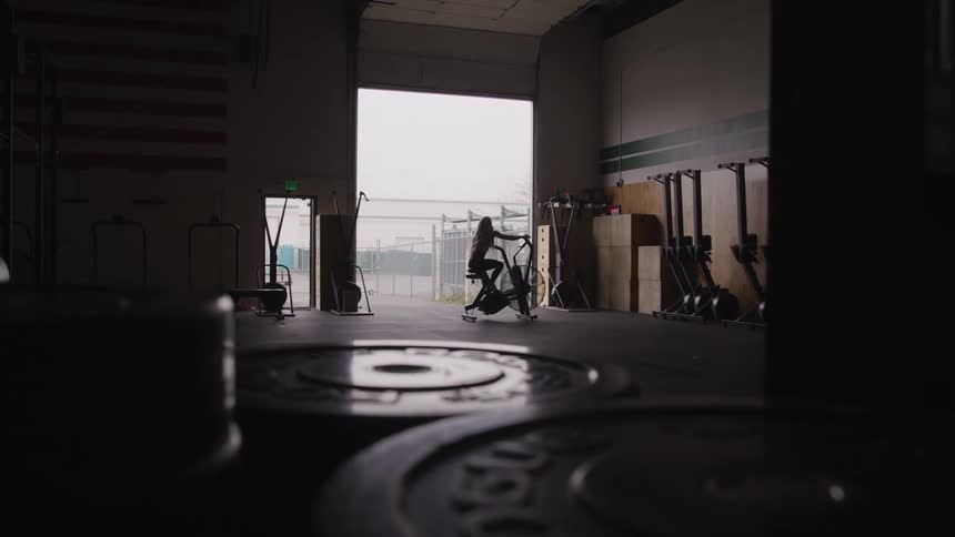 A woman is working out on the exercise machine