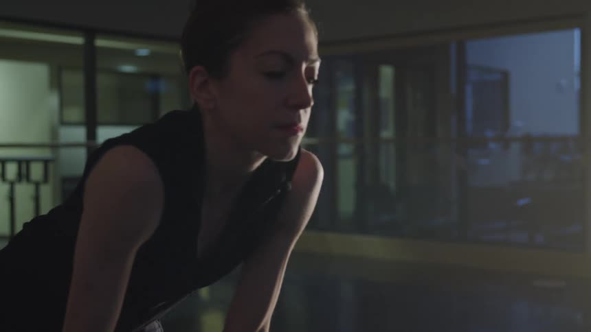 A ballet dancer is resting in the studio