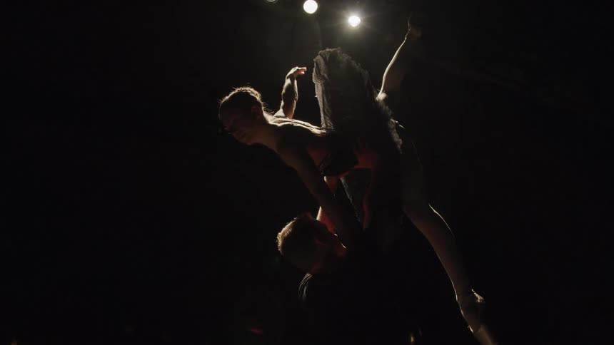 A ballet dancer is lifted up during a performance