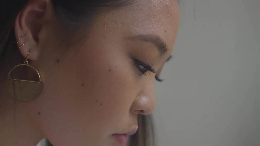 A woman is wearing makeup