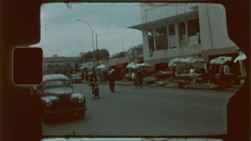 Streets of a city with pedestrians and old and classic cars