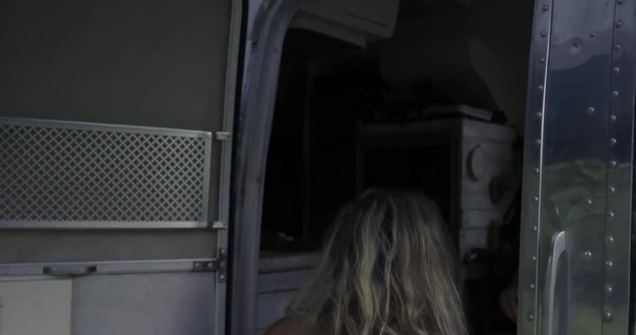 Two women walking into a camper vehicle