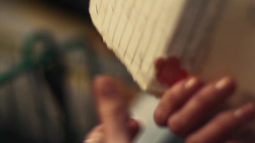 Pair of hands holding a sheet of paper with notes