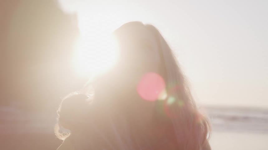 Portrait of a woman enjoying the scenery around her on the beach