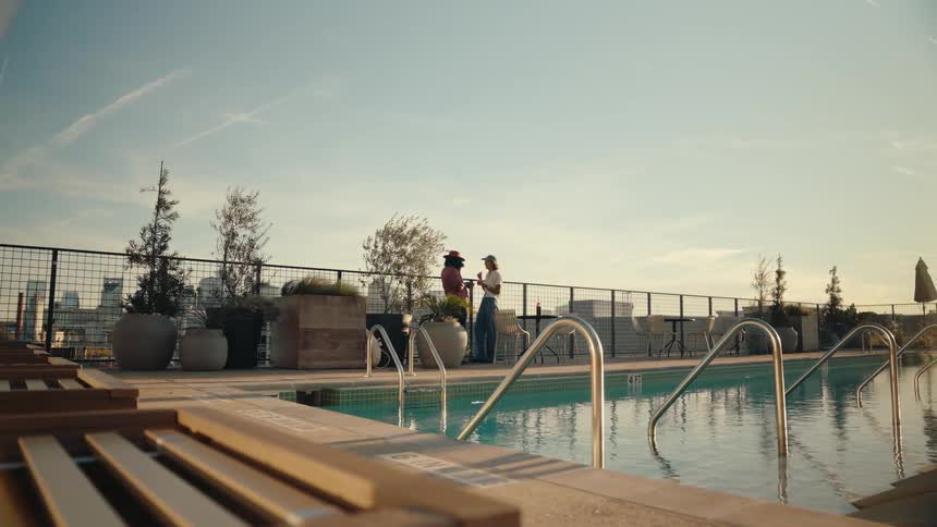Two people by the pool talking