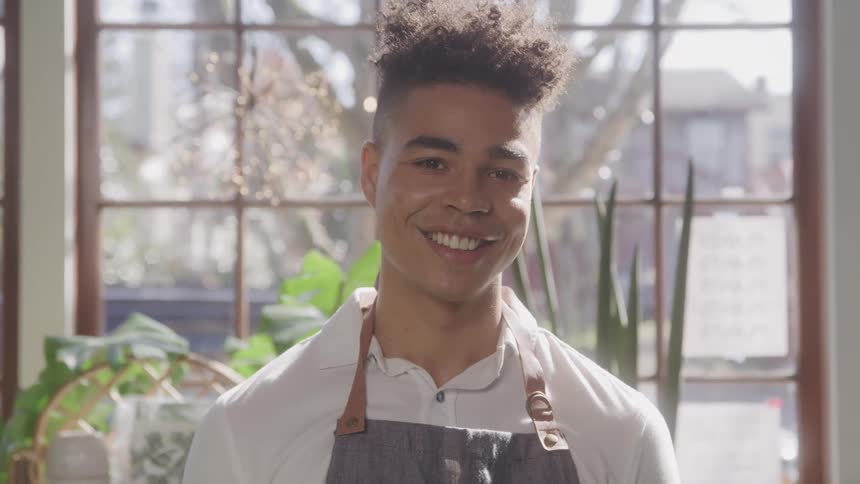 Smiling man wearing an apron
