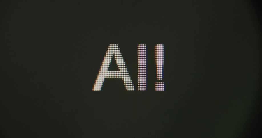 Close up of the letters ai being typed in a pixelated white font followed by a blinking cursor on a black screen