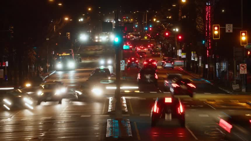 Time lapse of downtown traffic at night at a busy intersection