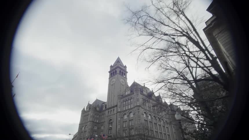Old post office building in washington dc towers over nearby buildings on an overcast winter day