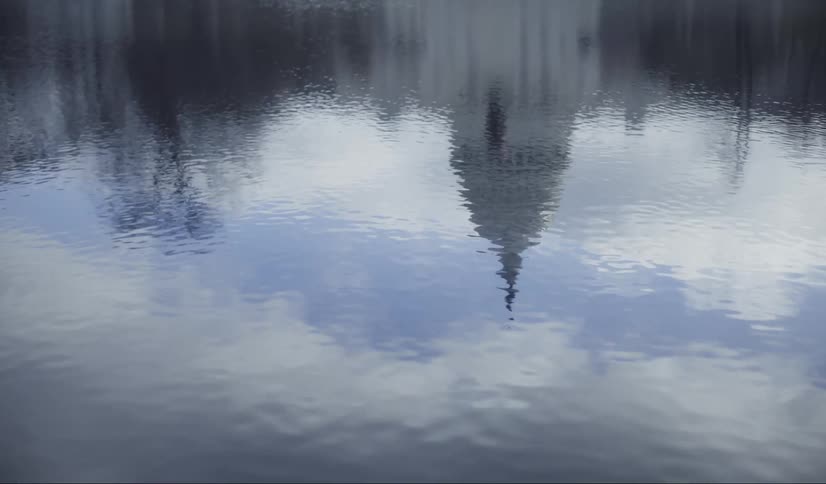 The water is reflecting the sky by the capital building
