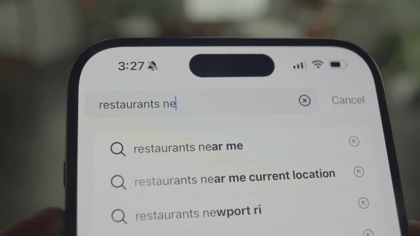 Text being typed into the search field of a smartphone