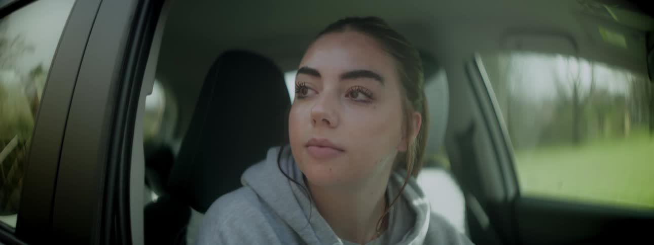 Woman opening car window and watching