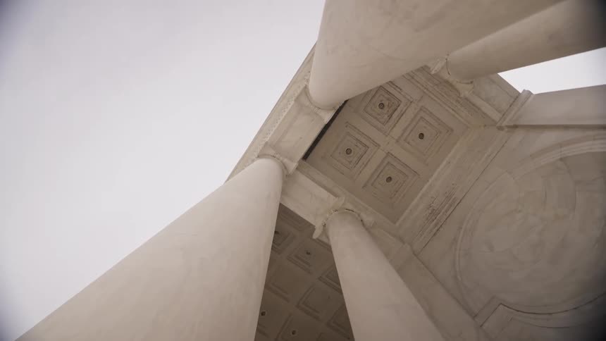 Large white pillars are on the building