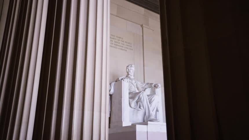 Tall columns border the statue of lincoln at the lincoln memorial