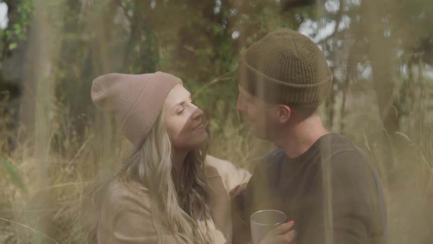 Couple lovingly embraces outdoors surrounded by nature