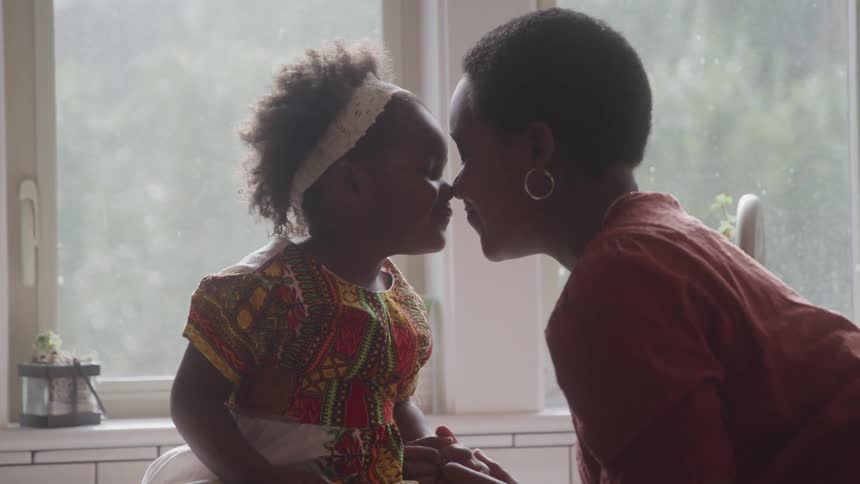 A mother and daughter rob noses together
