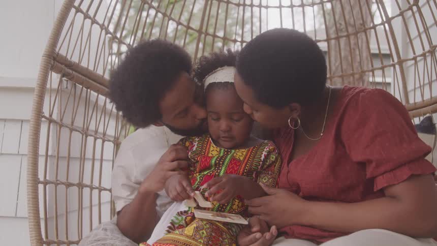 Parents hug their child